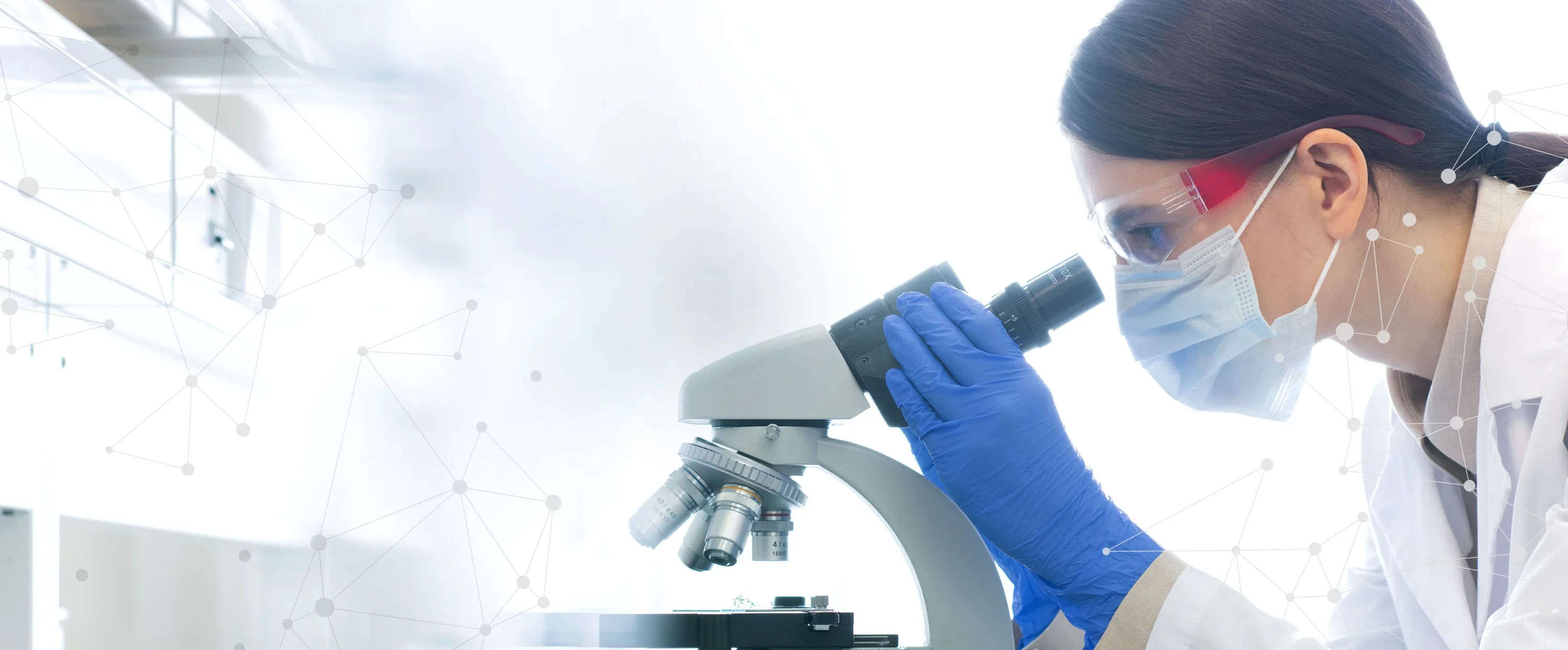 research scientist in a laboratory looking into microscope